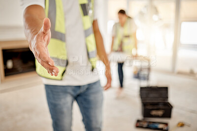 Buy stock photo Cropped shot of an unrecognisable construction worker standing inside with his hand outstretched for a handshake