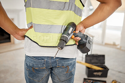 Buy stock photo Handyman, construction and drill in hand of a man for maintenance or carpenter work. Back of male engineer, constructor or contractor worker with electric power tools at building site for renovation