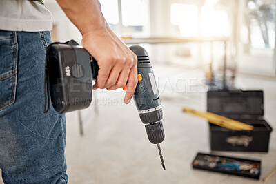 Buy stock photo Drill, handyman and hand of a man at construction site for maintenance or carpenter work. Back of male engineer, constructor or contractor worker with electric power tools in building for renovation