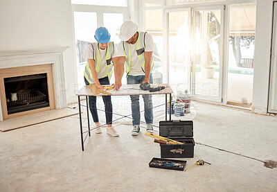 Buy stock photo Home renovation, construction and architect team at table for maintenance or architecture. Engineer man and woman talk and planning strategy with handyman tools for teamwork and collaboration project