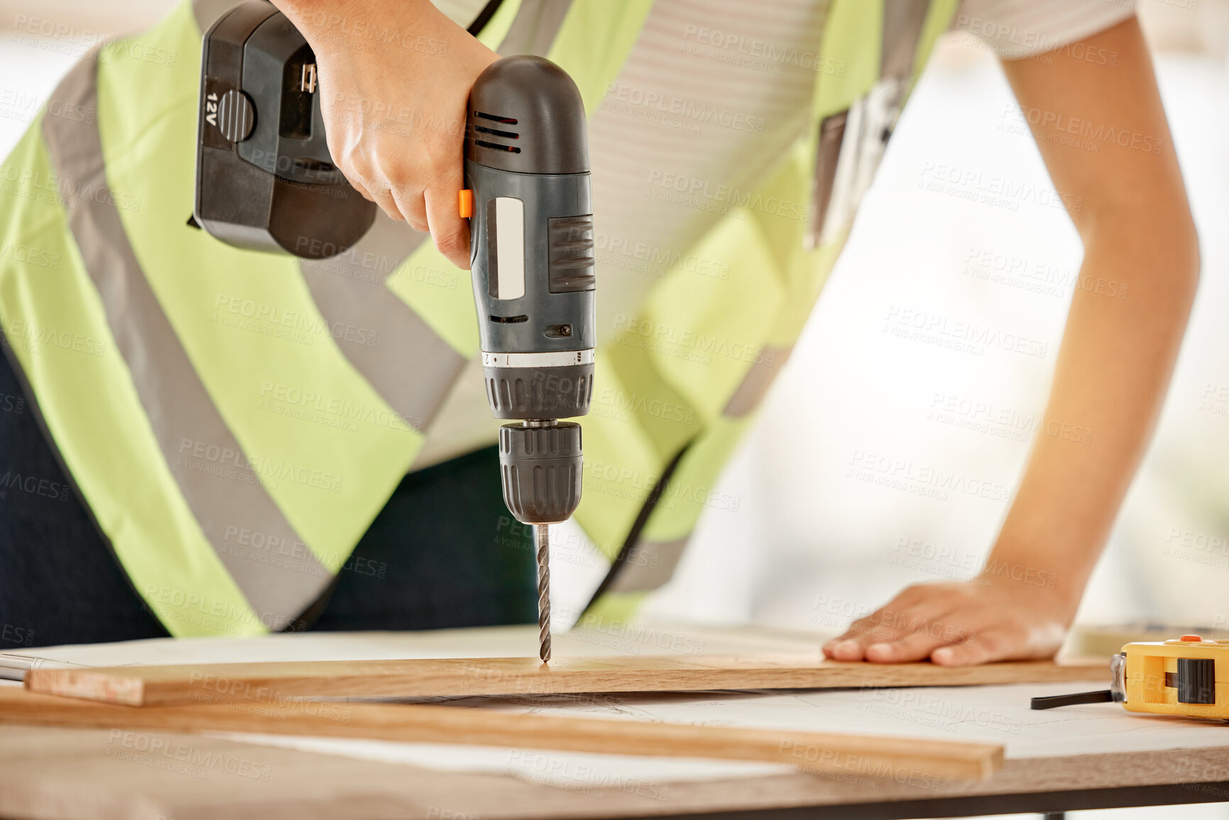 Buy stock photo Wood, construction and carpenter hand with a drill for repair, renovation or building. Hands of contractor, carpenter or technician person with electric power tools for furniture project in workshop