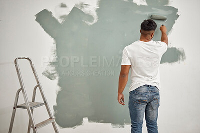 Buy stock photo Painting, DIY and back of man in living room for home decor, creativity and inspiration at wall. Male person, new house or project in lounge for interior design, renovation or decorating in apartment