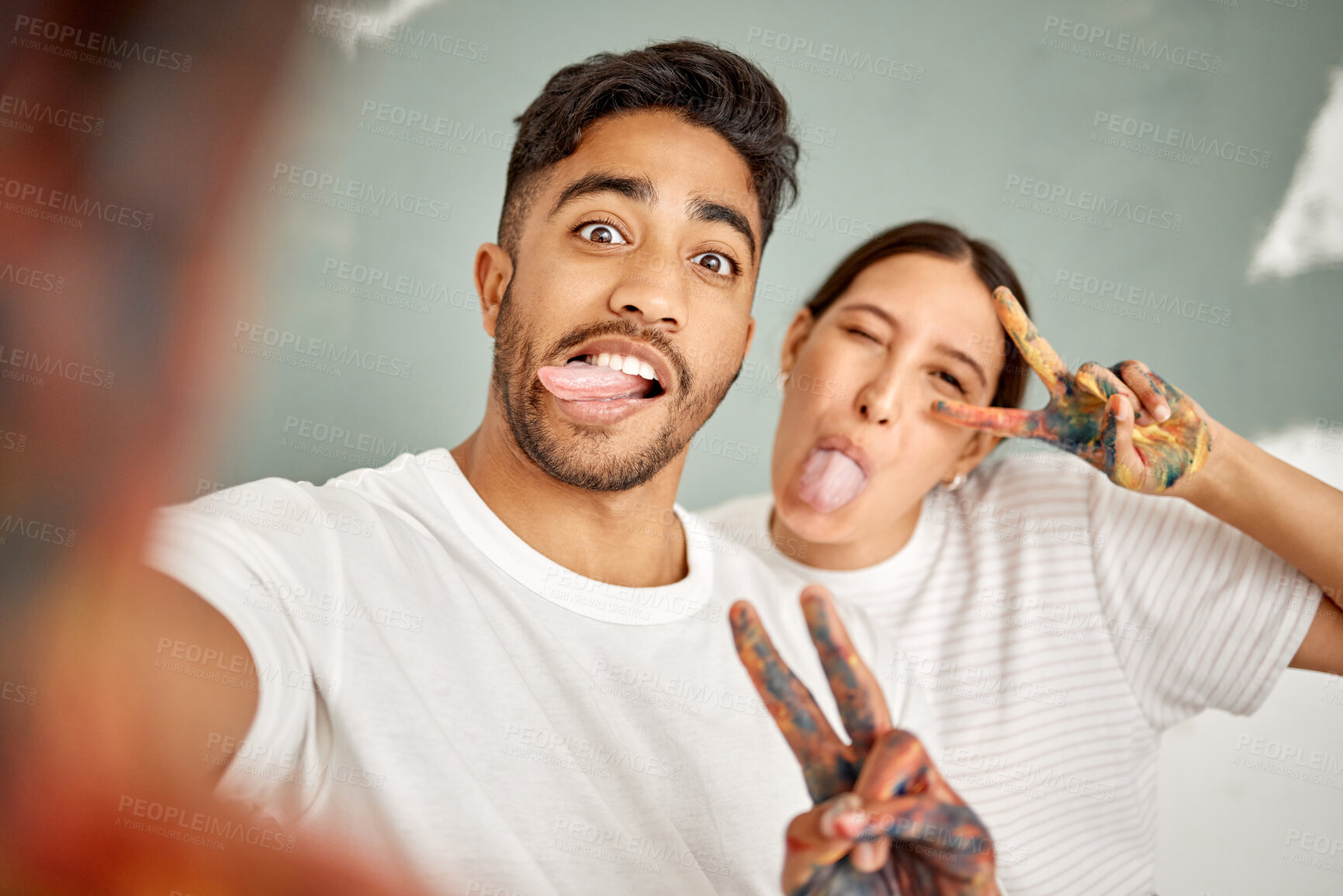 Buy stock photo Goofy, selfie and happy couple for home renovation, diy or house remodel together with peace hands. Silly, profile picture and man with woman, excited and creative for mural, art or paint maintenance