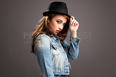 Buy stock photo Confident, streetwear and girl in studio, Gen z and fashion for portrait, mock up and clothes to relax. Brown background, cool and hat for accessory, proud and person with aesthetic and model of USA