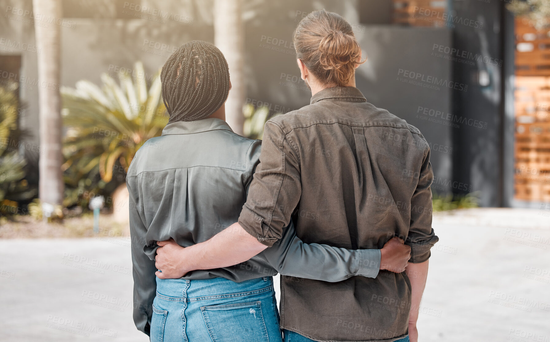 Buy stock photo Outdoor, hug and couple with new house, property and sunshine with real estate, moving in and interracial. Rear view, man and woman with embrace, home loan and achievement with mortgage, sale or rent