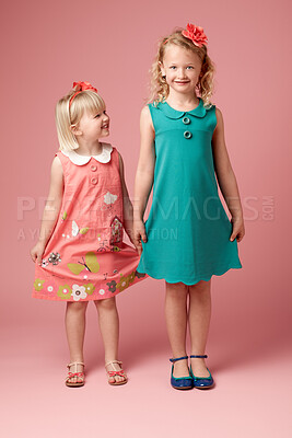 Buy stock photo Portrait, studio background and siblings for fashion with vintage clothes, young girls and development. Family, pink backdrop and retro with dress for children, style inspiration and love together