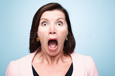 Buy stock photo Portrait, wow and surprise of shocked woman with fear in studio isolated on a blue background. Face, omg and wtf of model with announcement, secret news or emoji expression for gossip information