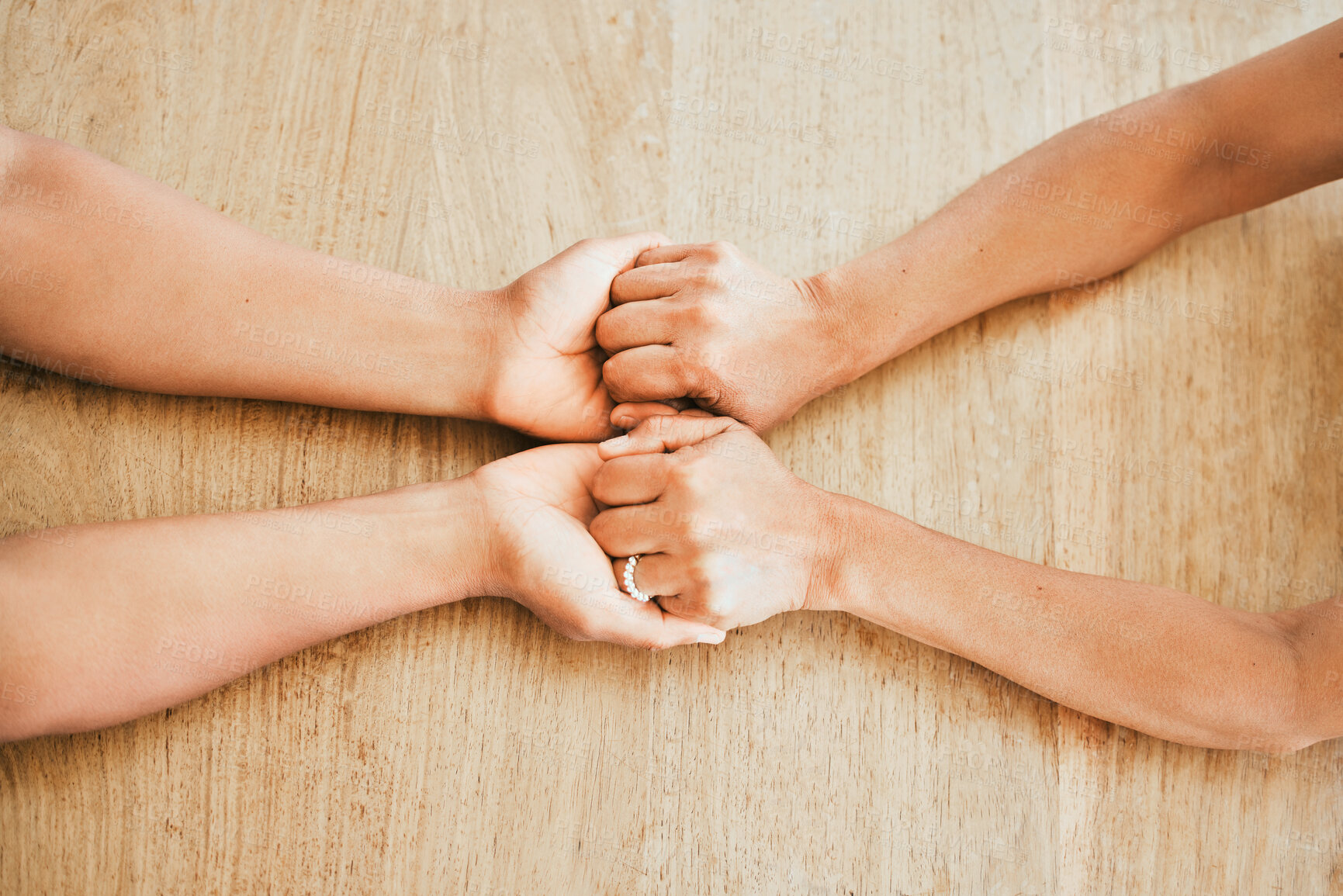 Buy stock photo Top view, couple and helping hands for support, trust or love with empathy on wooden table at home. Comfort, people or kindness for hope, care or connection together for marriage reconciliation above