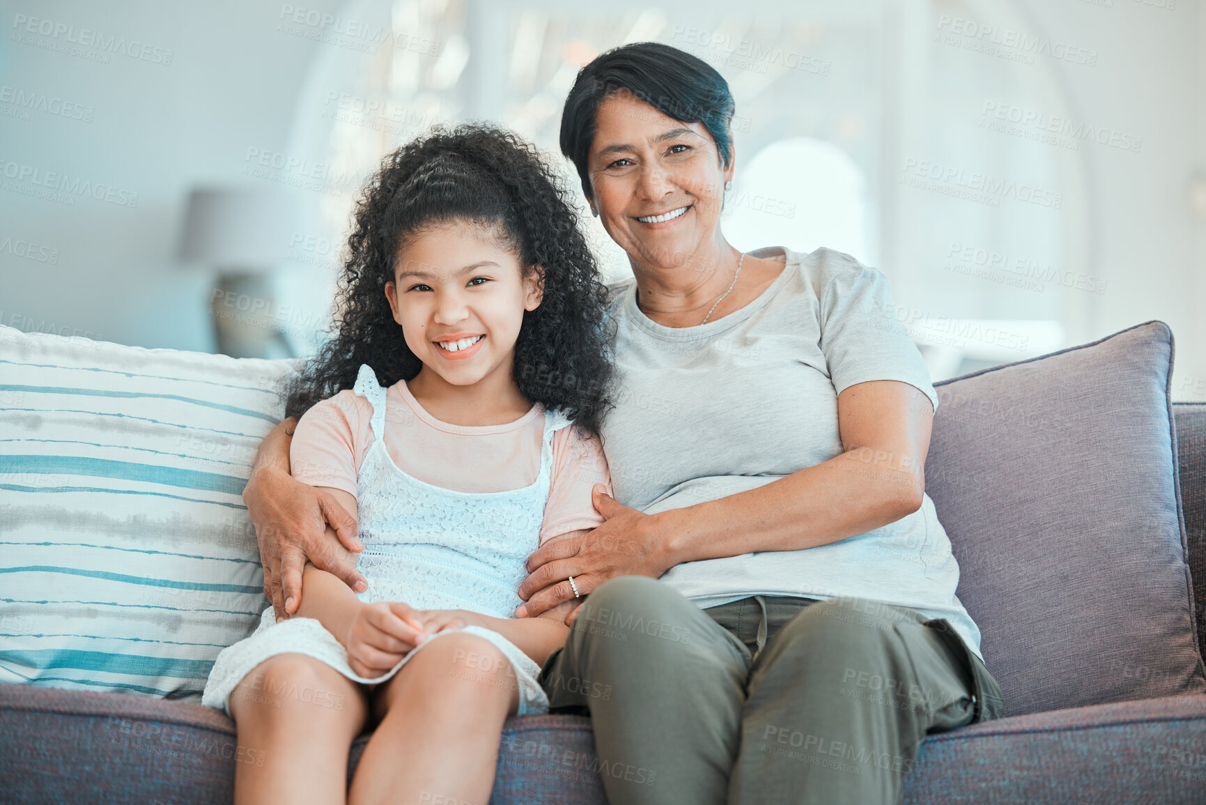 Buy stock photo Grandmother, child and hug in portrait on couch with happiness, love and support in home. Family, care and smile together in living room, apartment or relax on sofa in house with senior woman