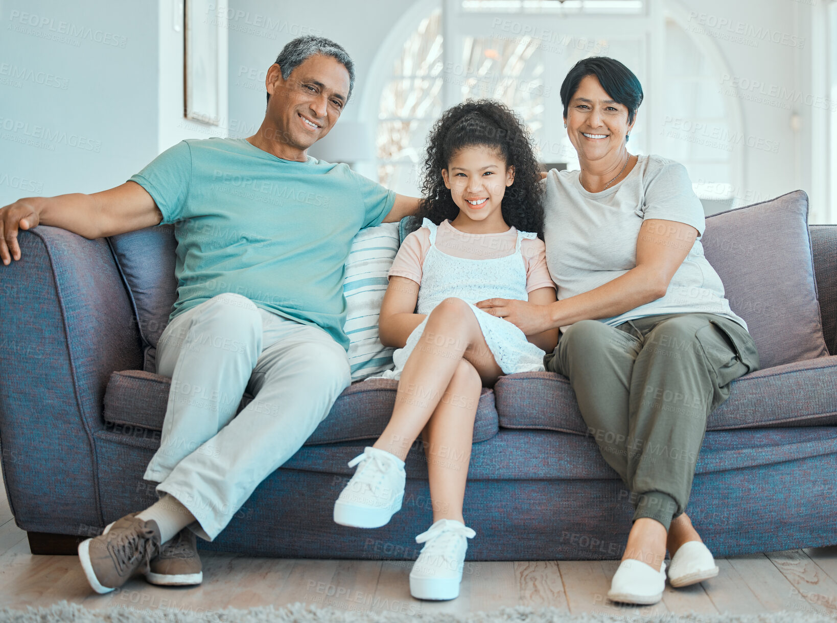 Buy stock photo Grandparents, happy and portrait of girl  on couch to relax in house or home with smile, support and care together. Break, grandmother and grandfather with child on sofa for bonding, wellness or love