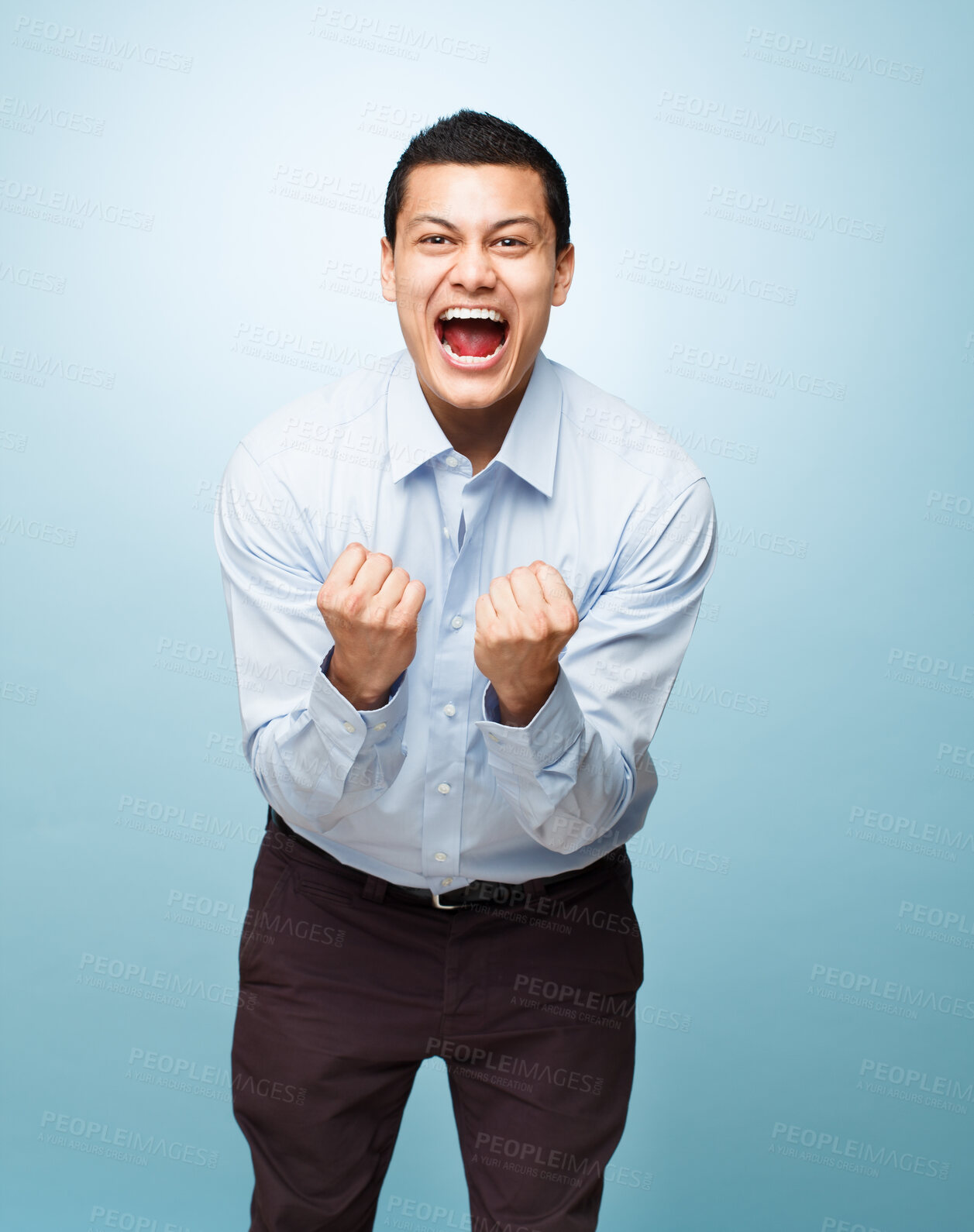 Buy stock photo Portrait, screaming and man with celebration, excited or achievement on blue studio background. Face, person or model with promotion, victory or wow with emotion, reaction or omg with bonus or winner