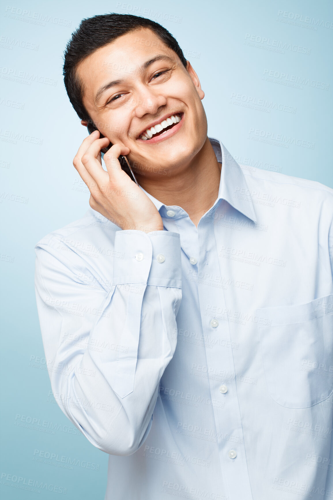 Buy stock photo Phone call, smile and portrait of businessman in studio for corporate communication for  b2b deal. Happy, contact and Asian lawyer with cellphone for mobile discussion isolated by blue background.