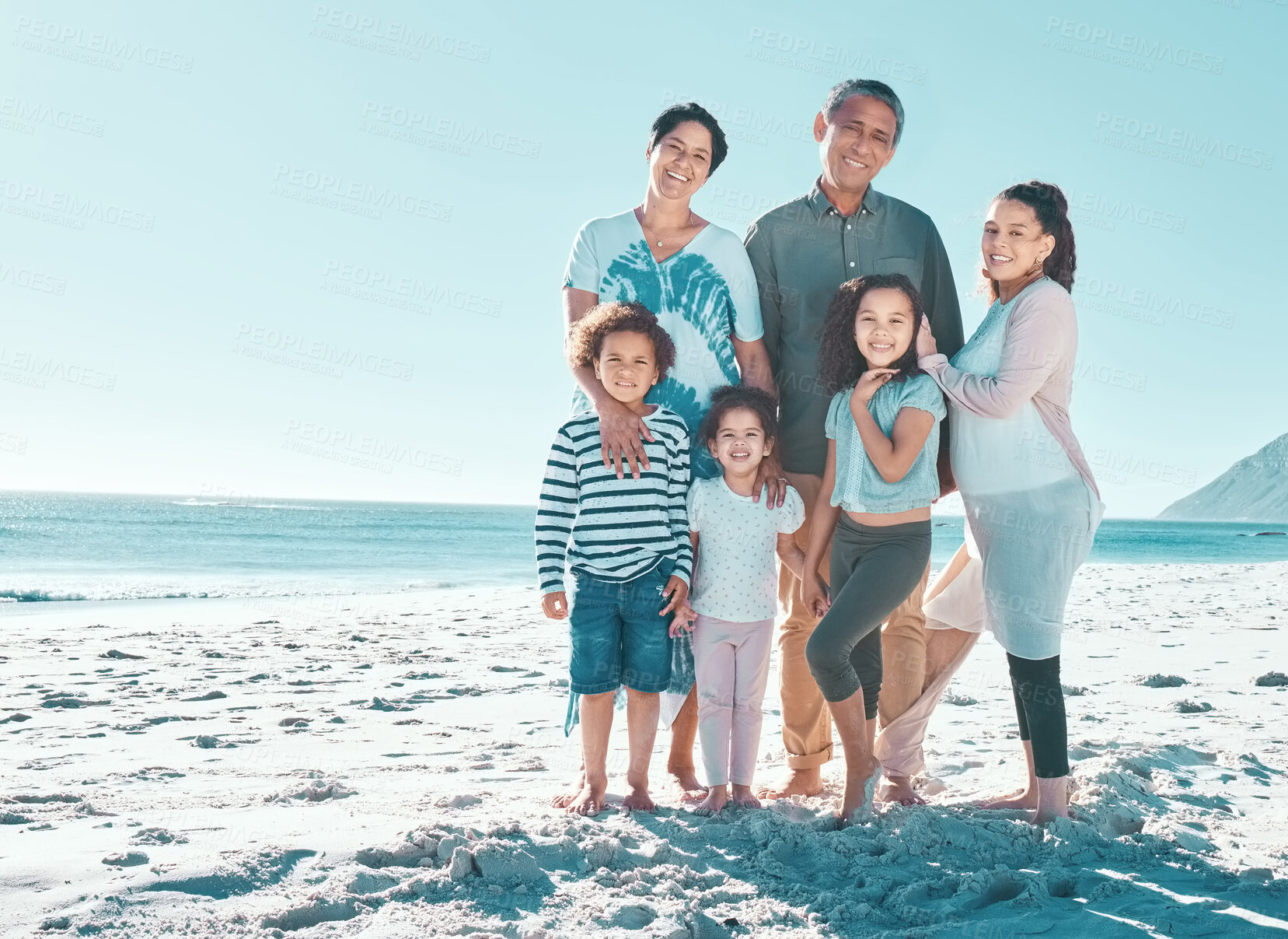 Buy stock photo Portrait, generations and happy family at beach for holiday, summer and people travel on tropical island vacation. Grandparents, mother and kids together at ocean for relax, tourism or mockup space