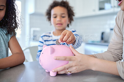 Buy stock photo Cropped shot of an unrecognizable mother teaching her kids about savings at the kitchen table