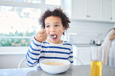 Buy stock photo Shot of an adorable little boy having breakfast at the kitchen table