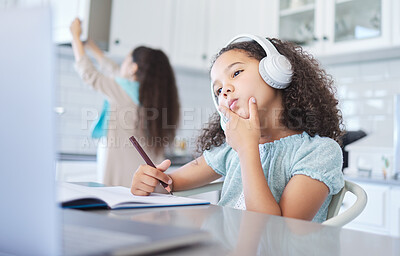 Buy stock photo Shot of a little girl looking thoughtful well doing her homework at the kitchen table