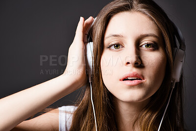 Buy stock photo Woman, portrait and headphones in studio for music listening or podcast, subscription or streaming. Female person, face and black background for online audio with media sound, radio or connection