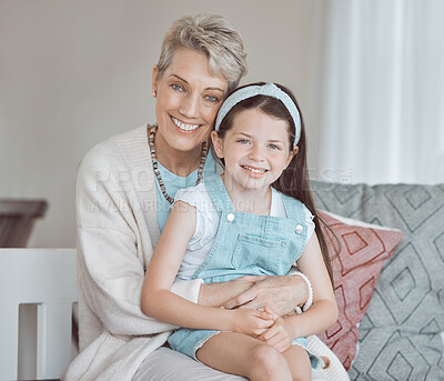 Buy stock photo Shot of a mature woman bonding with her granddaughter at home