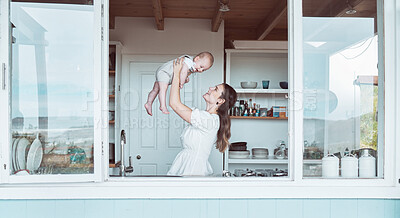 Buy stock photo Shot of a beautiful young mother bonding with her newborn at home