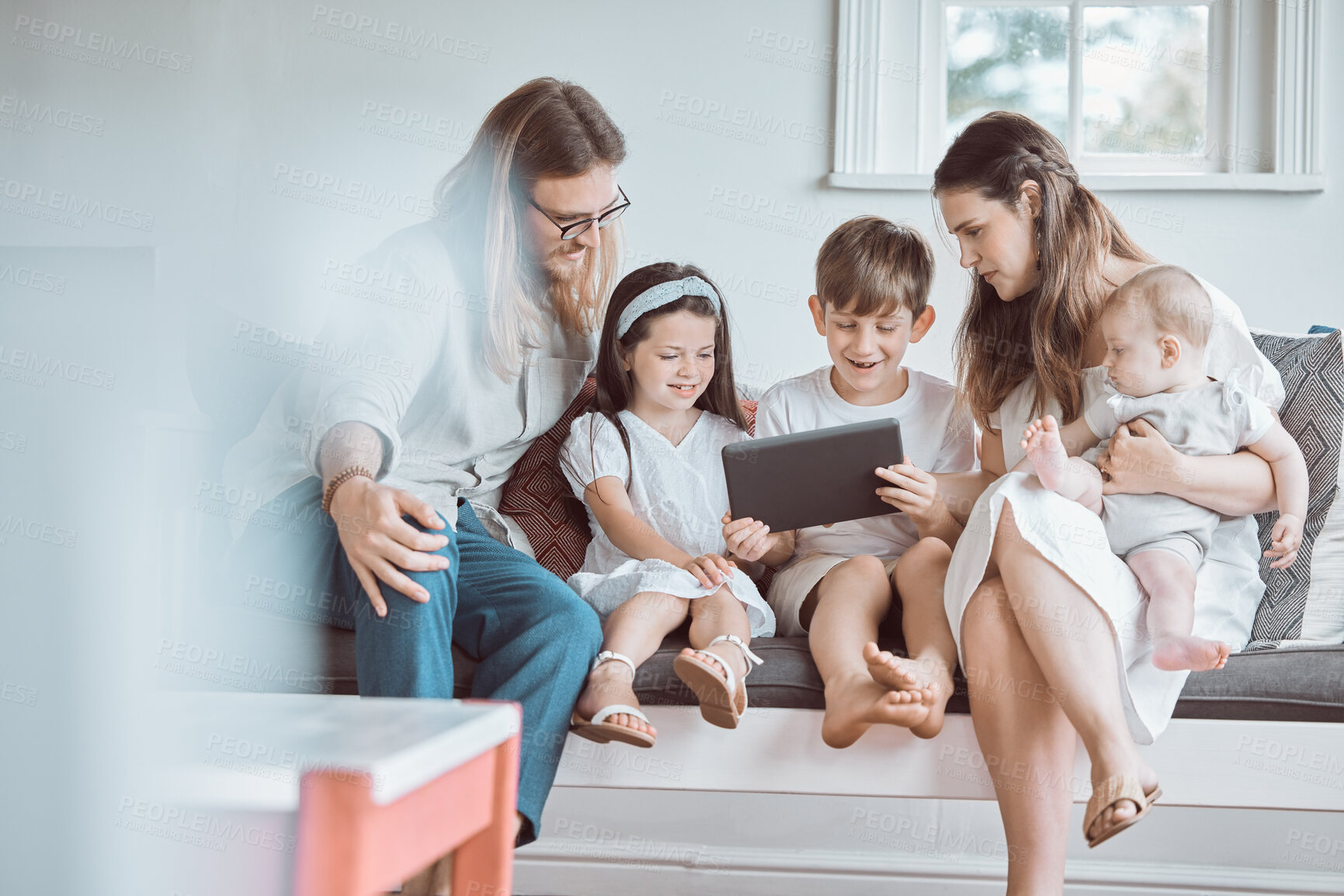 Buy stock photo Shot of a young family bonding together at home