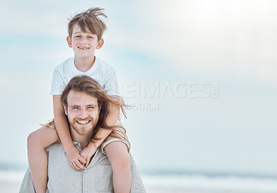 Buy stock photo Shot of a young father and son spending time together at the beach
