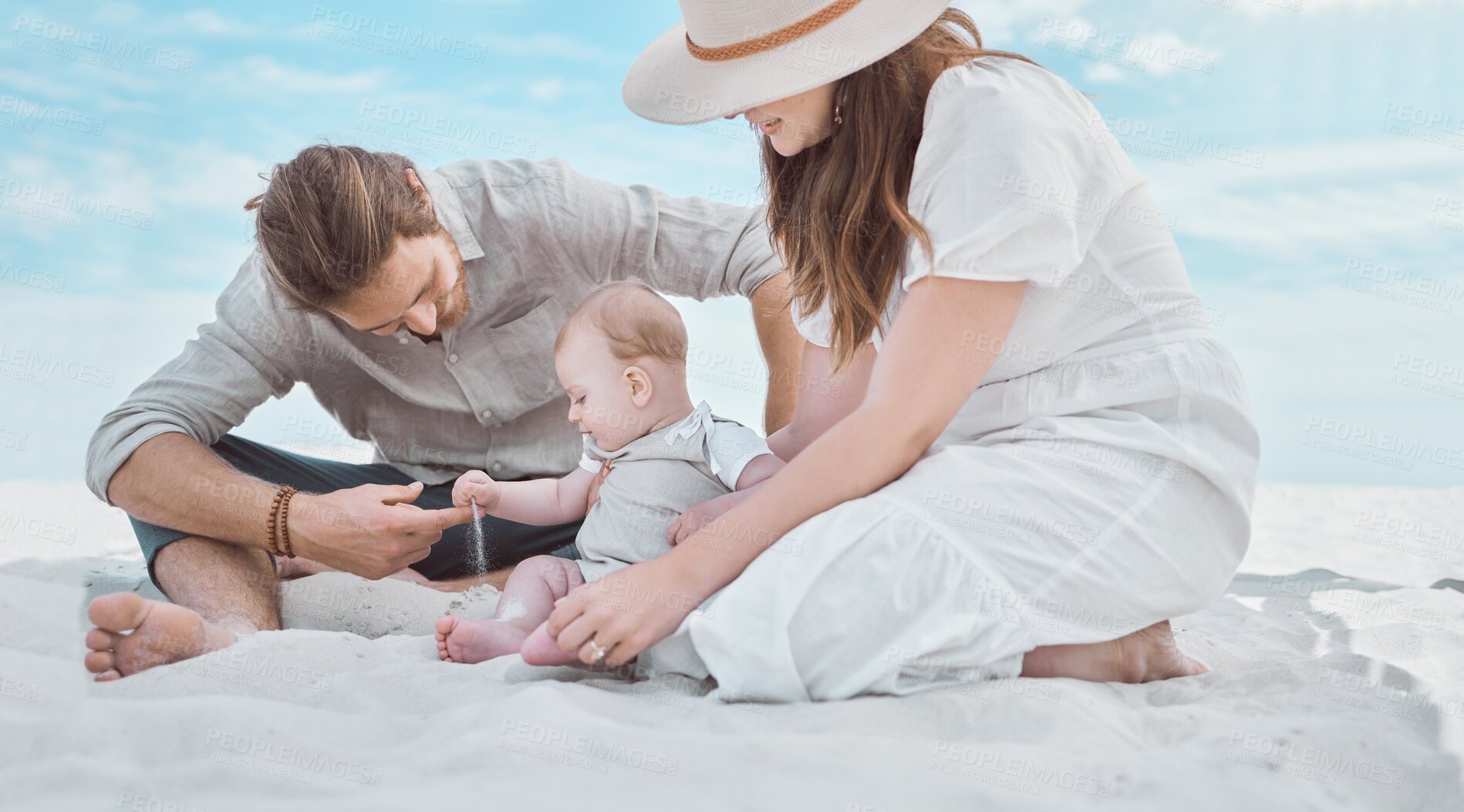 Buy stock photo Shot of a young family spending a day at the beach