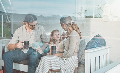 Buy stock photo Shot of a couple drinking coffee while sitting at home with their daughter