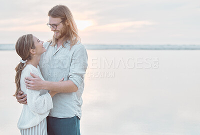 Buy stock photo Shot of an affectionate couple spending time together at the beach