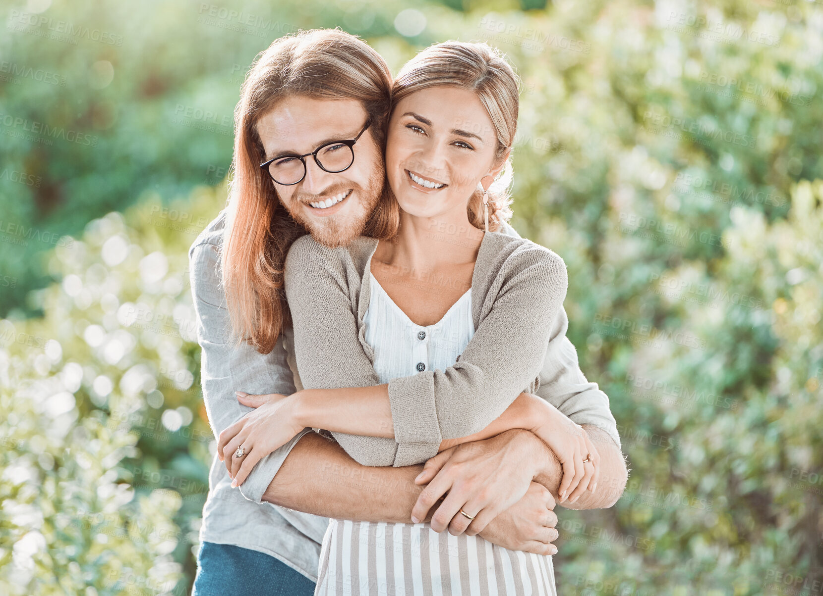 Buy stock photo Couple, hug and smile for portrait in garden with care, bonding and outdoor in spring for connection. People, man and woman with embrace, love and happy together in backyard by trees in Croatia