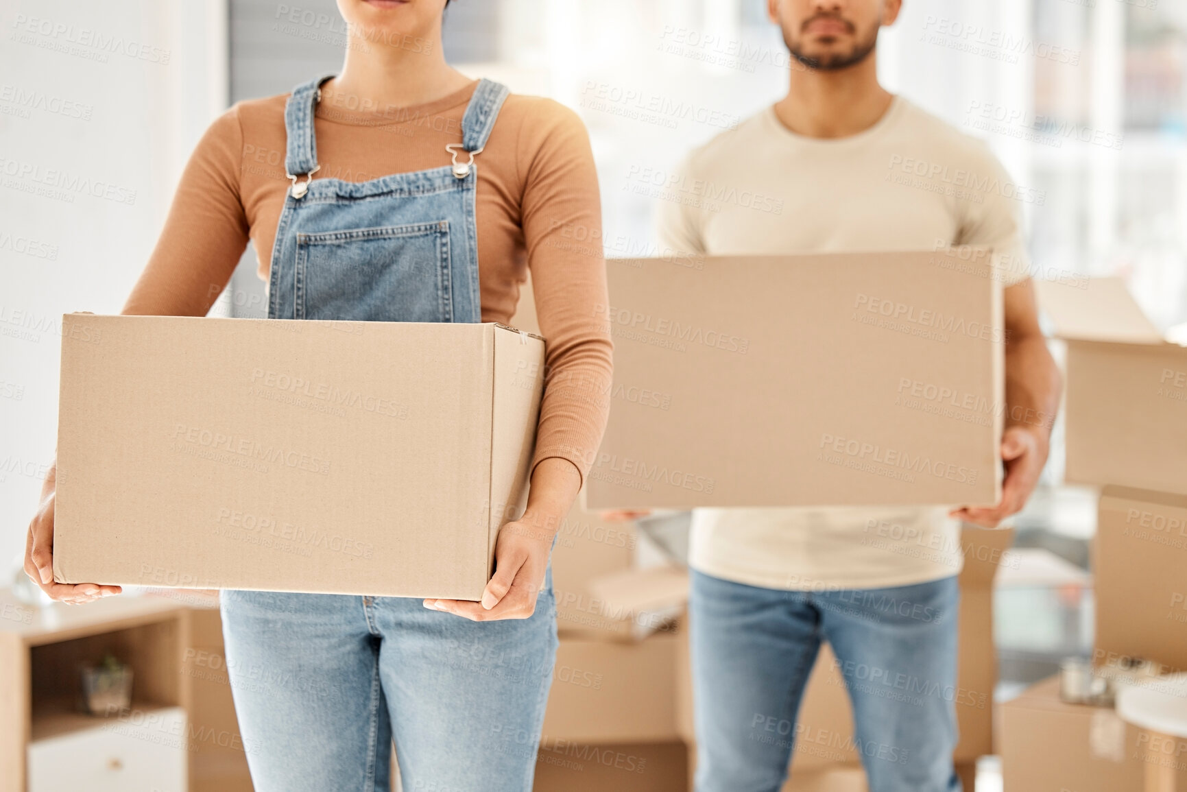 Buy stock photo Couple, moving and boxes in house for property investment, relocation and home loan for rental apartment together. Mortgage, carrying packages and assets in living room, real estate and people