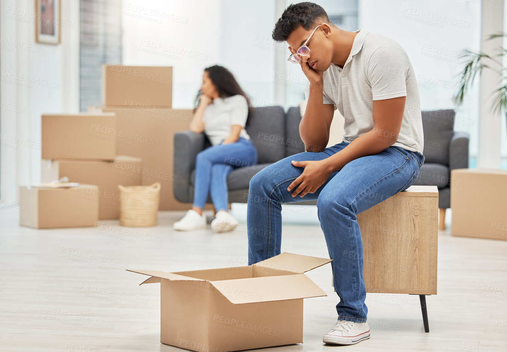 Buy stock photo Couple, unhappy and man worry with box for moving stress, lost items and overwhelmed with change of home. Woman, sofa and upset with partner for furniture placement, disagreement and miscommunication