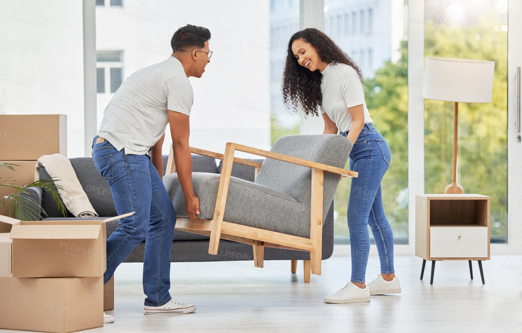 Buy stock photo New home, happy couple and moving furniture in living room for interior design together. Man, woman and carry chair in property for remodeling, unpacking or house improvement in apartment renovation