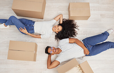 Buy stock photo Portrait, top view and happy couple moving in new home for real estate, mortgage and investment together. Relax, woman and laughing man rent property, apartment and excited for relocation on floor