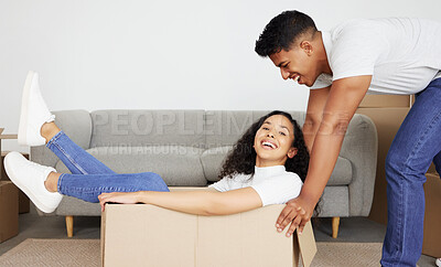 Buy stock photo Real estate, happy couple and push in box for moving, mortgage and new home investment together. Portrait, man and laughing woman in cardboard to celebrate property rental or play game in apartment