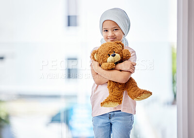Buy stock photo Healthcare, child and portrait of a cancer patient holding a teddy bear for support or comfort. Medical, smile and girl kid with leukemia standing with a toy after treatment in a medicare hospital.