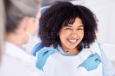 Buy stock photo Shot of a young female patient having her teeth examined at the dentist