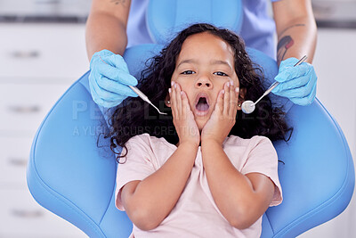 Buy stock photo Shot of a little girl looking shocked at the dentist