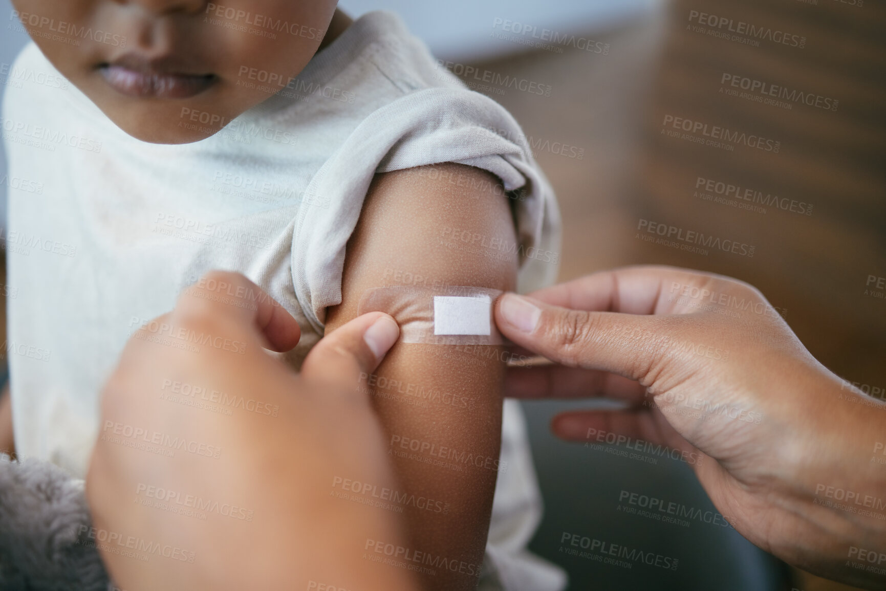 Buy stock photo Hands, pediatrician and arm of kid with plaster for immunization shot, medication or injection. Healthcare, consultation and doctor with child for medical vaccine treatment with bandage in clinic.