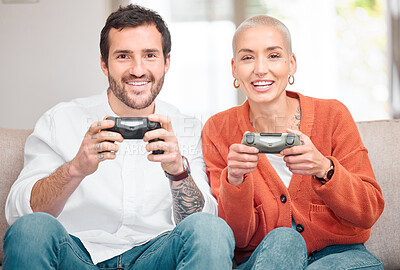 Buy stock photo Cropped portrait of an affectionate young couple playing video games at home