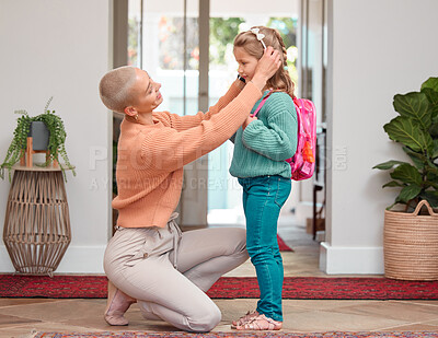 Buy stock photo Education, getting ready or goodbye with mother and daughter in home for development or growth. Back to school, dressing and farewell with single woman parent helping girl child in apartment