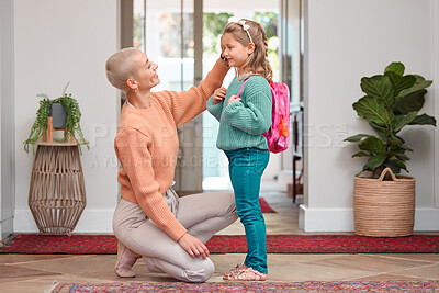 Buy stock photo Dressing, education or goodbye with mother and daughter in home for development or growth. Back to school, getting ready and farewell with single woman parent helping girl child in apartment