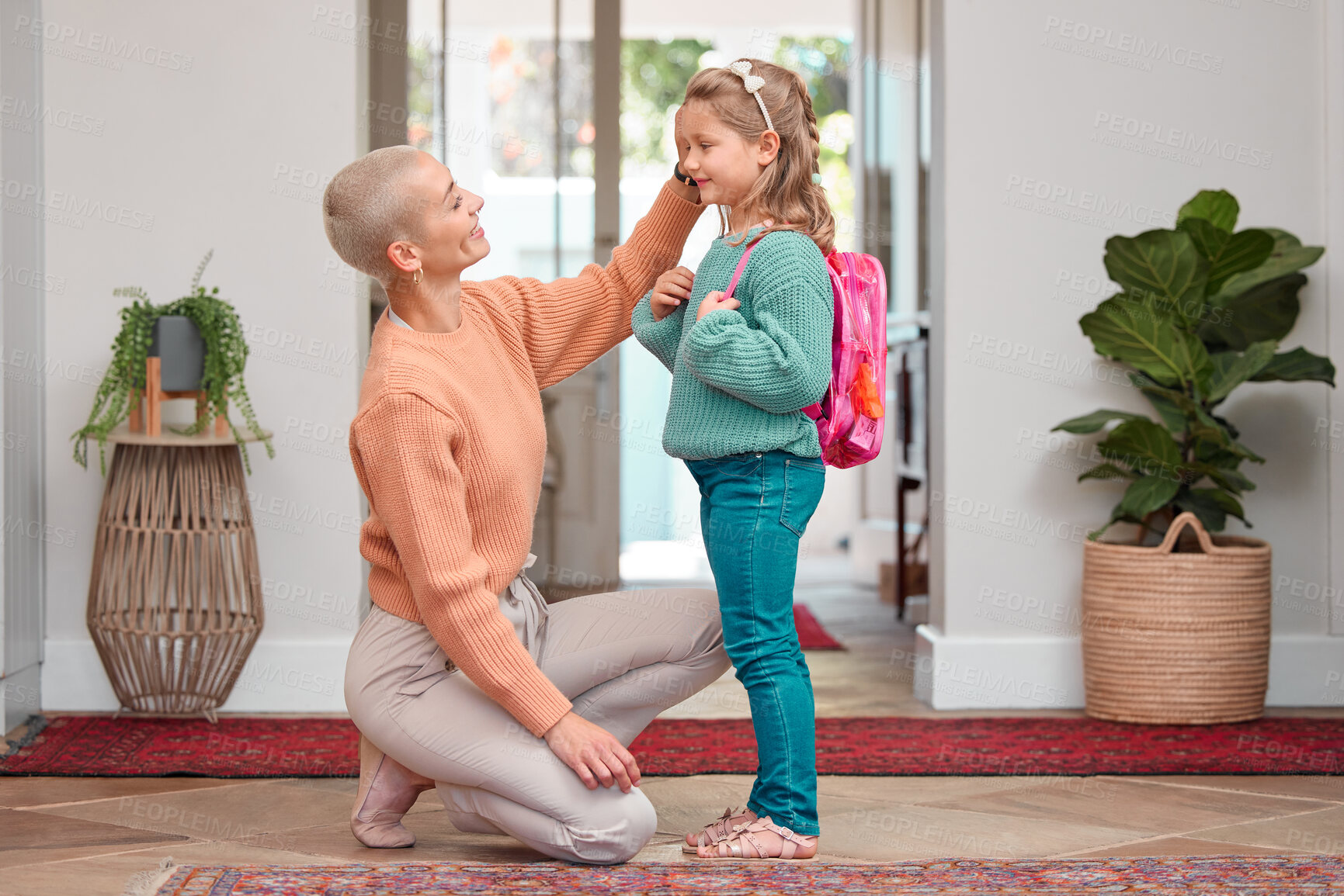 Buy stock photo Dressing, education or goodbye with mother and daughter in home for development or growth. Back to school, getting ready and farewell with single woman parent helping girl child in apartment