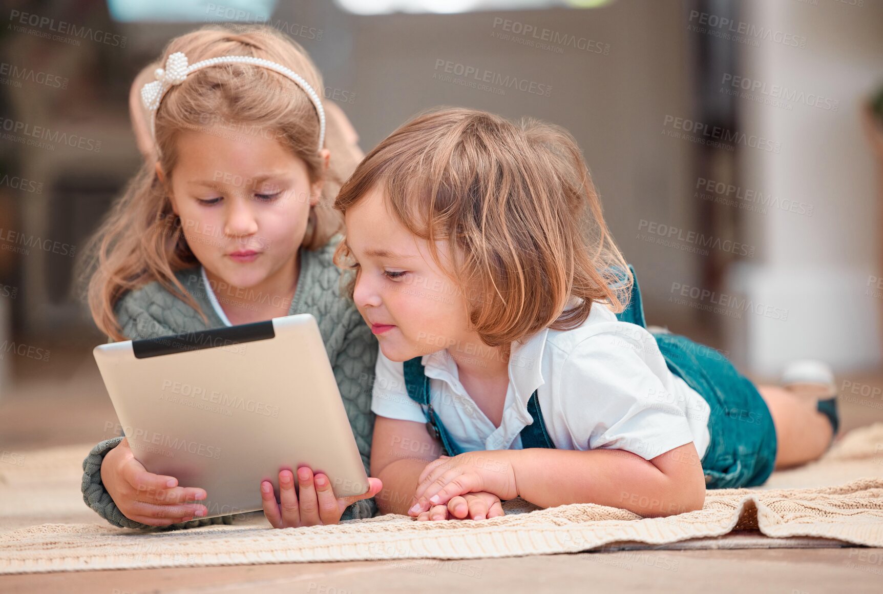 Buy stock photo House, typing and siblings on floor, tablet and happiness with internet, connection and relax in lounge. Kids, apartment and brother with sister, technology and playing with online game or comfort