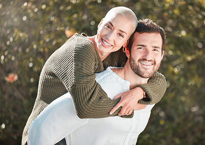 Buy stock photo Cropped portrait of a handsome young man piggybacking his wife outdoors