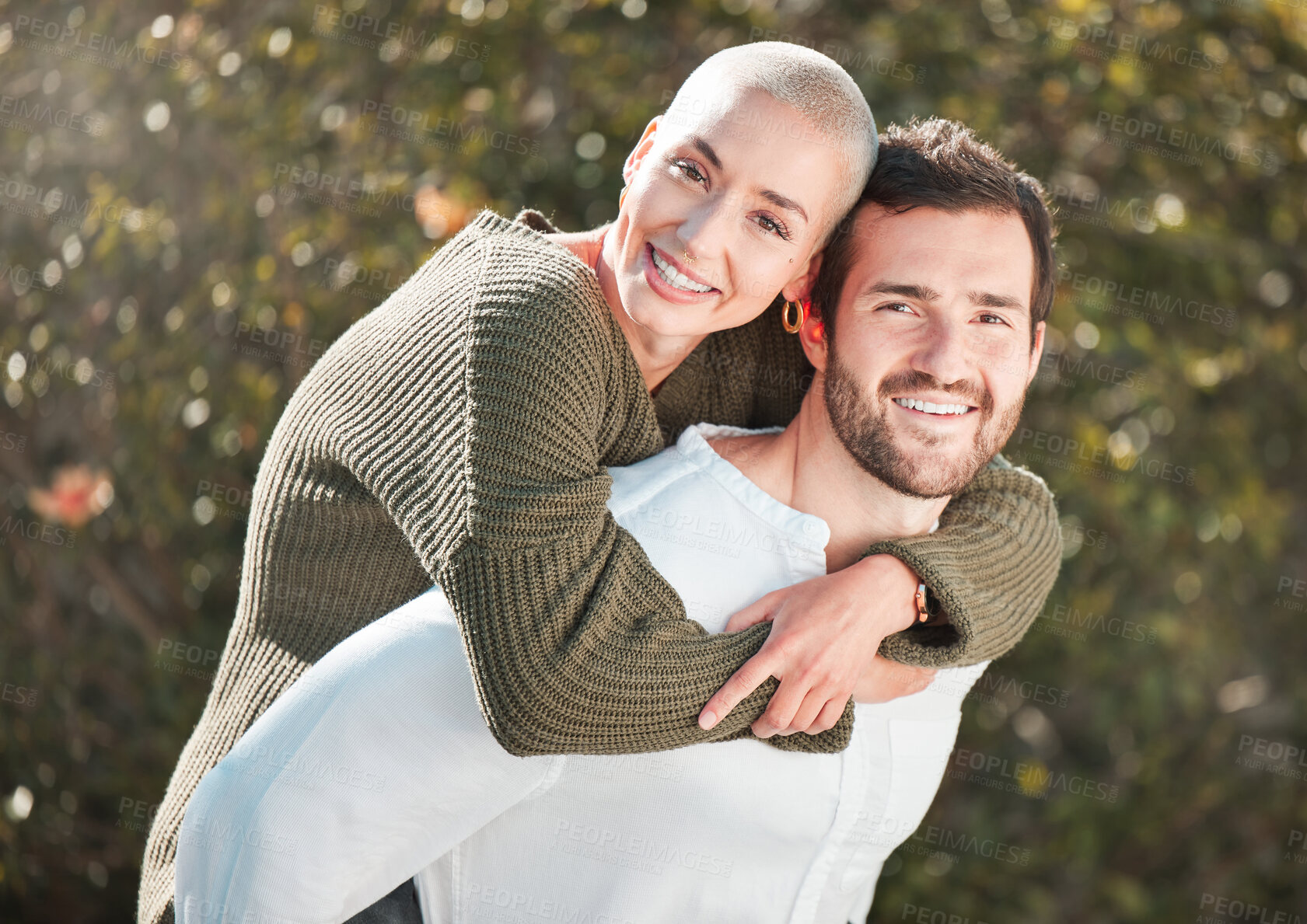 Buy stock photo Cropped portrait of a handsome young man piggybacking his wife outdoors