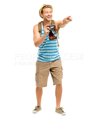 Buy stock photo Man, point and camera in studio for tourism with smile, travel and excited with backpack by white background. Person, photographer and shooting on holiday, perspective and memory with direction