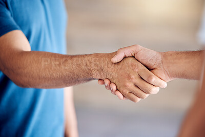 Buy stock photo Cropped shot of two people shaking hands in an office