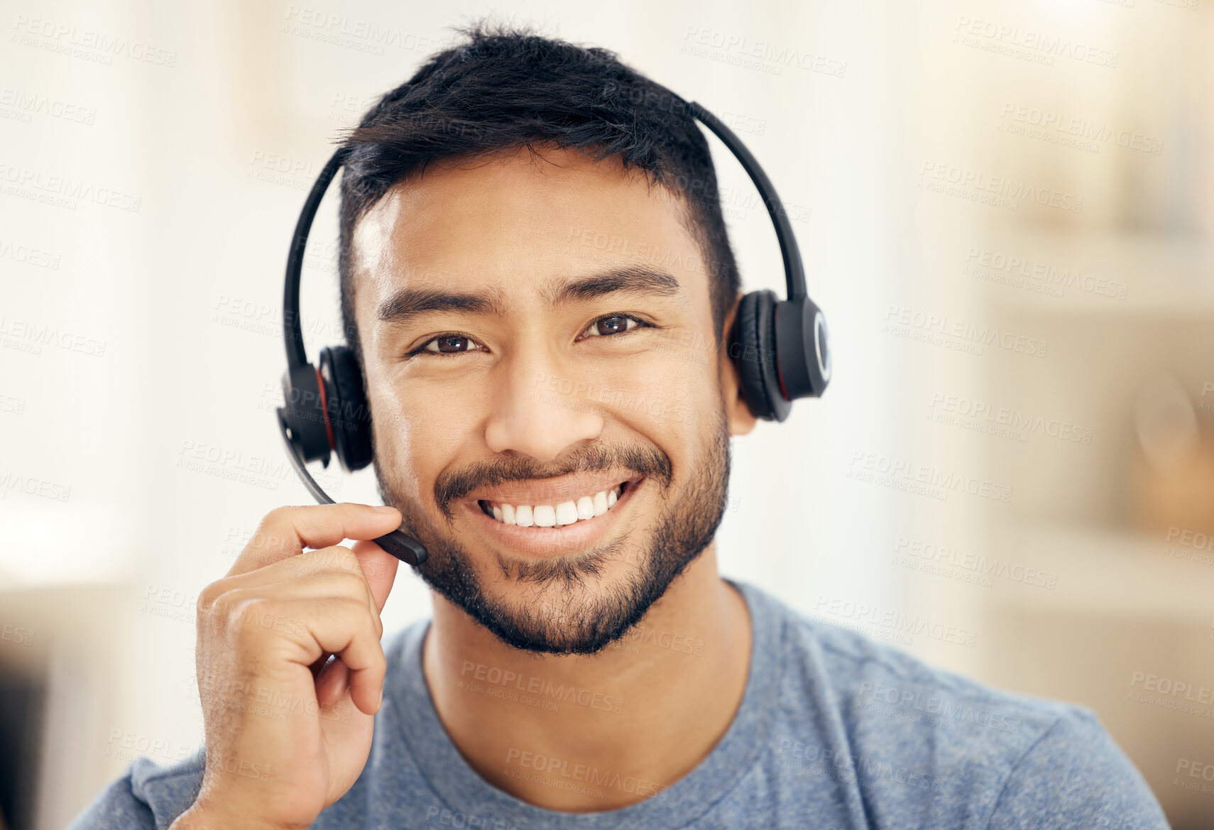 Buy stock photo Shot of a young male call center agent working in an office