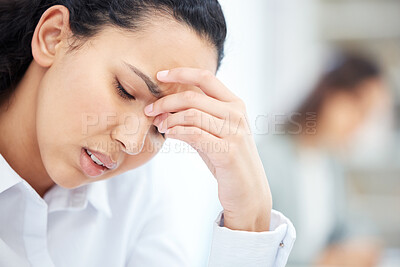 Buy stock photo Shot of a young businesswoman looking overwhelmed in an office at work