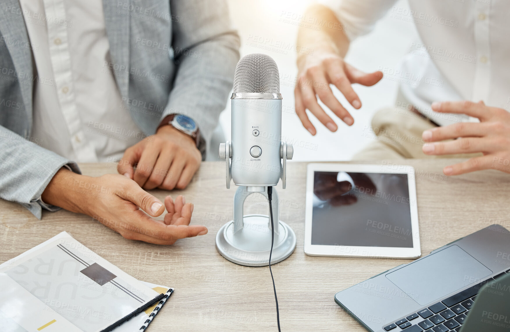 Buy stock photo Podcast, interview and business people hands, microphone and broadcast, talking or news, finance and advice in office. Radio, live streaming and professional person, partner or startup team planning